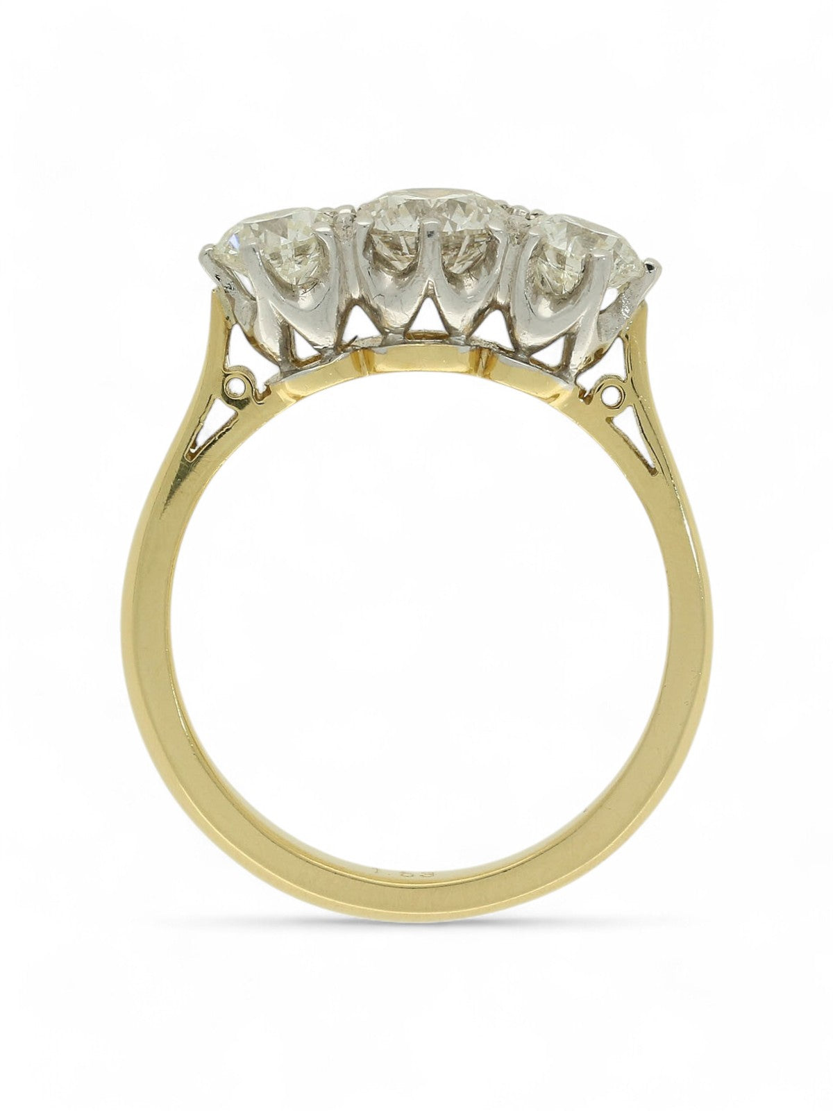 Three stone diamond ring with a yellow gold shank on a white background.
