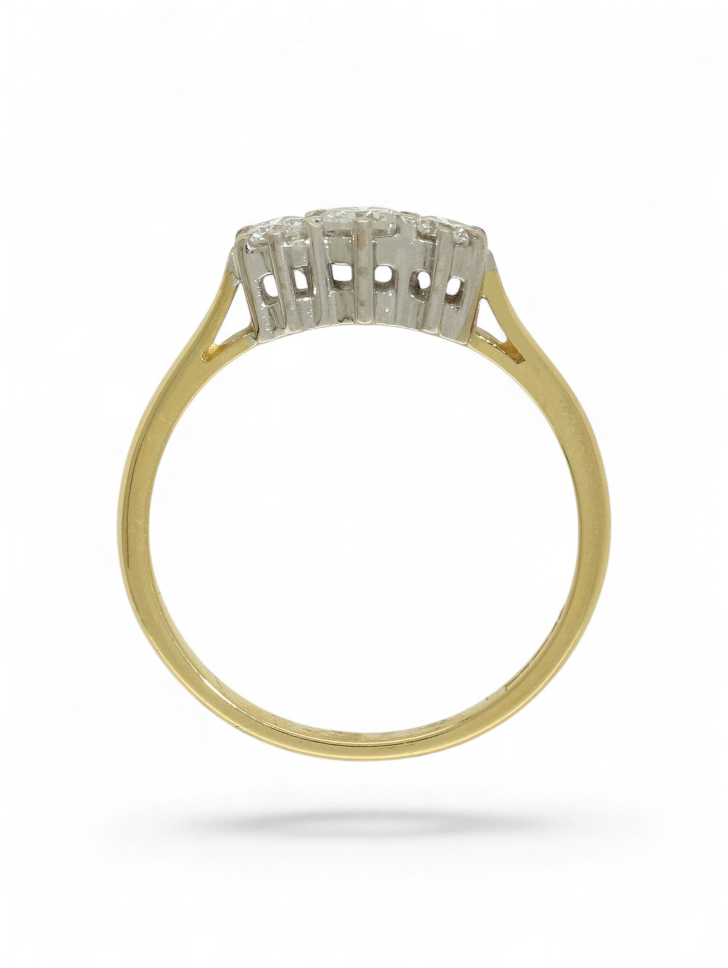 18ct yellow and white gold three-stone diamond ring on a white background.