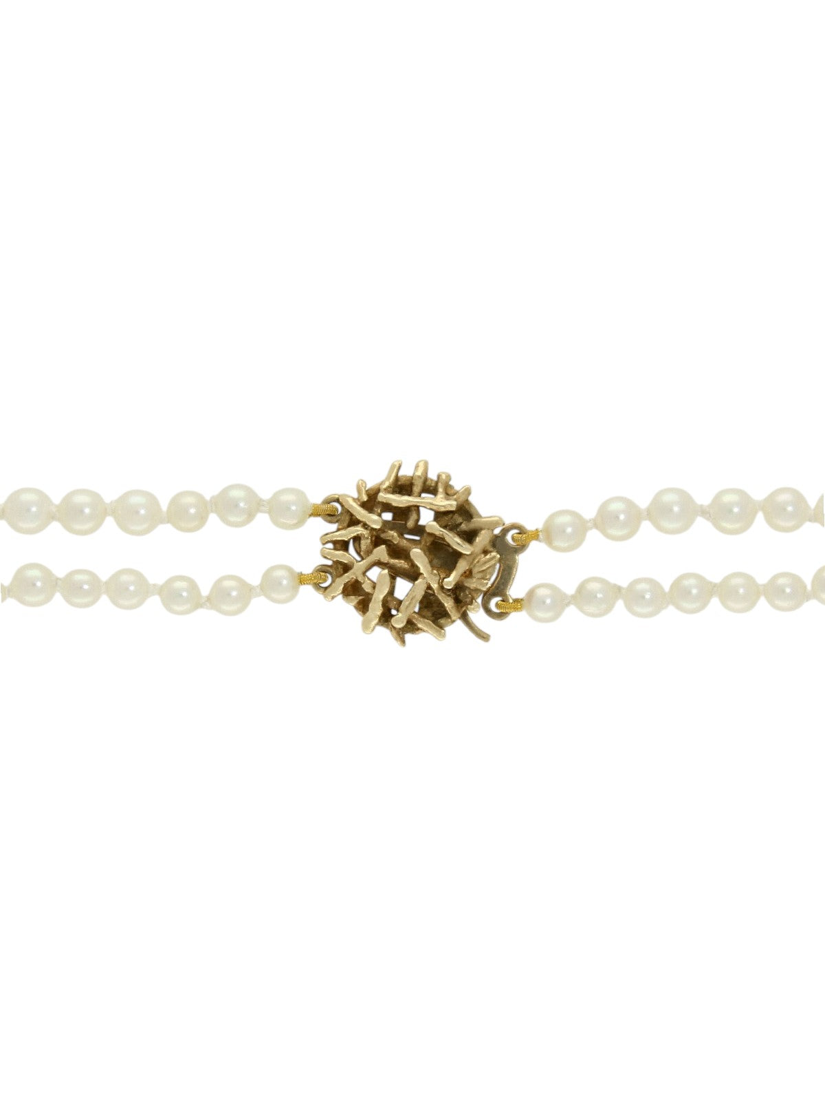 Yellow gold clasp attached to two strands on white pearls on a white background.