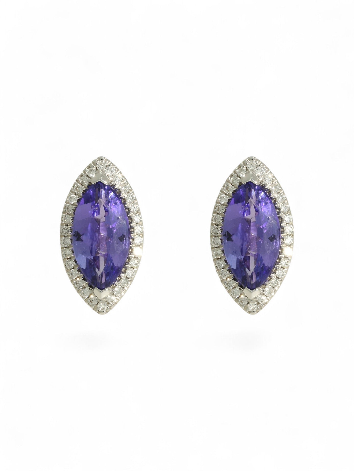 Tanzanite & diamond marquise cluster earrings on a white background.