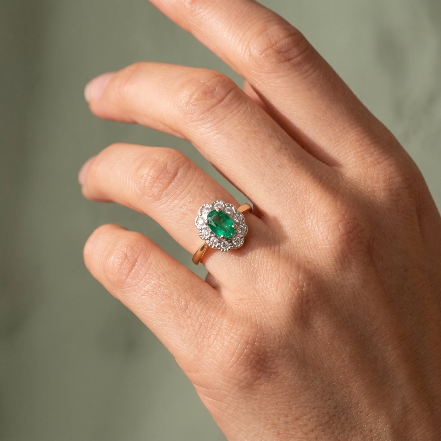 Emerald & Diamond Cluster Ring with 7x5mm Emerald and 0.10ct of Round Brilliant Diamonds in 9ct Yellow & White Gold