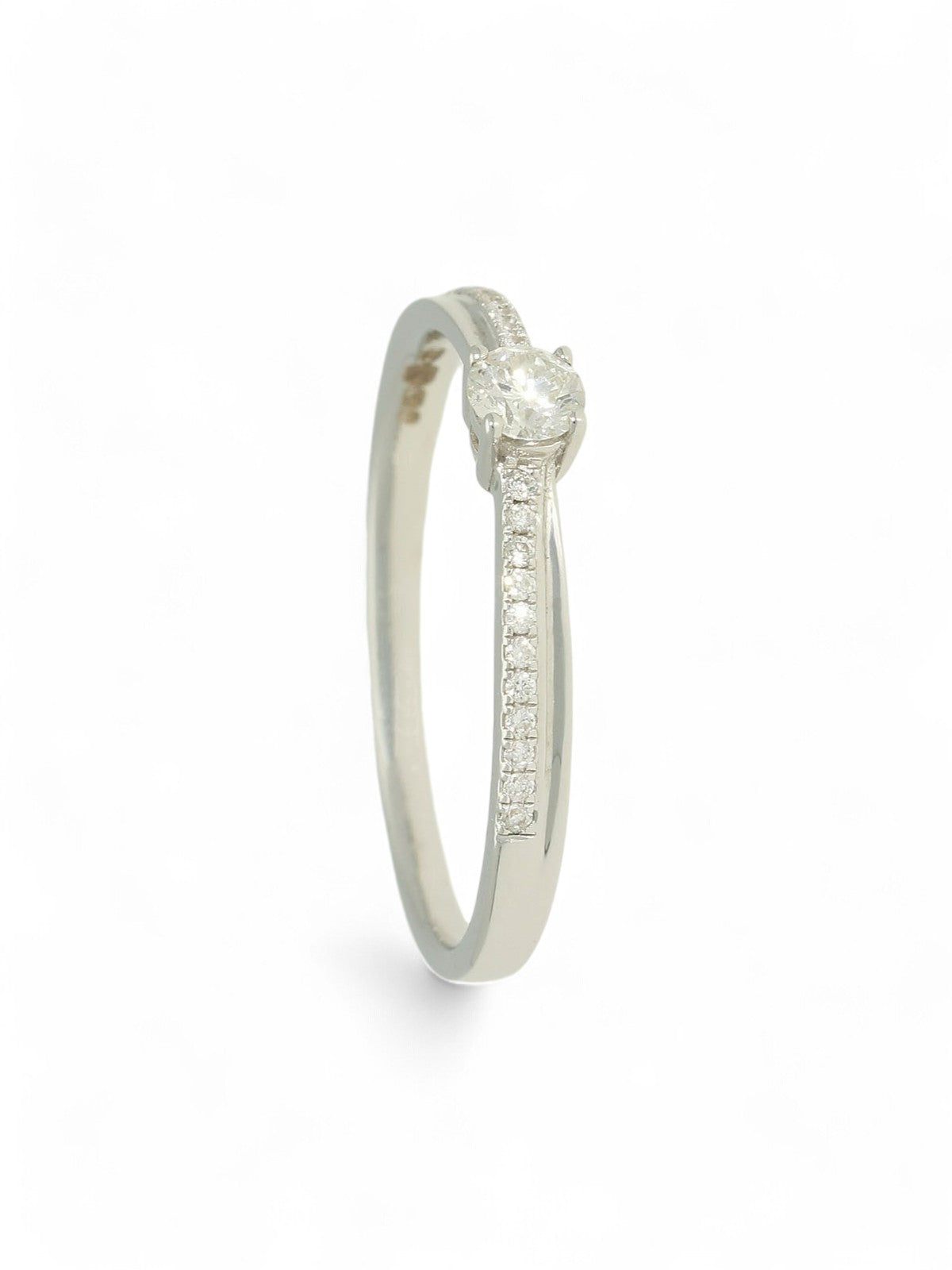 Diamond solitaire ring with round brilliant -cut centre and diamond-set shoulders in white gold on a white background.