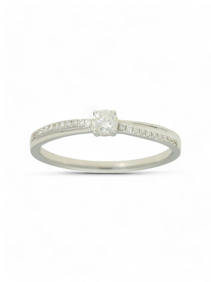 Diamond solitaire ring with round brilliant -cut centre and diamond-set shoulders in white gold on a white background.