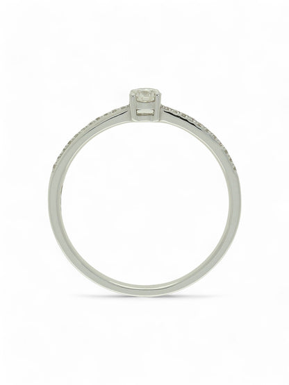 Diamond solitaire ring with round brilliant -cut centre and diamond-set shoulders in white gold on a white background.