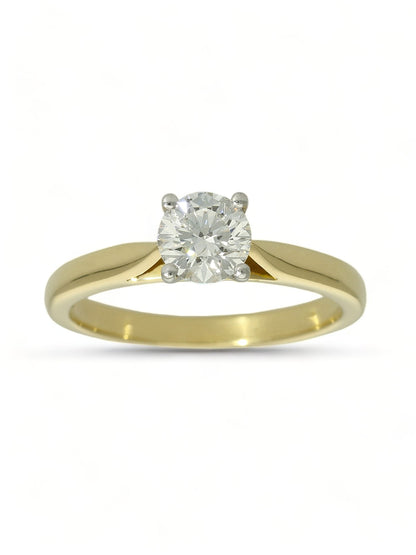 Lab grown diamond ring in a four-claw setting with a yellow gold band on a white background.
