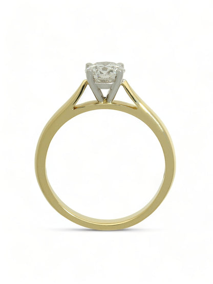 Lab grown diamond ring in a four-claw setting with a yellow gold band on a white background.