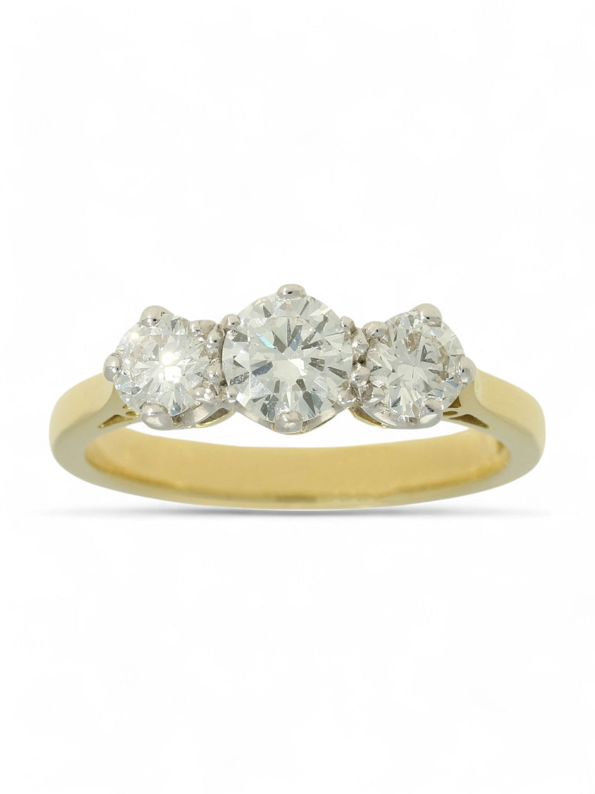 Three stone diamond ring with a yellow gold shank on a white background.