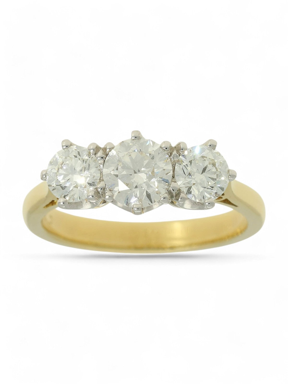 Three stone diamond ring with a yellow gold shank on a white background.