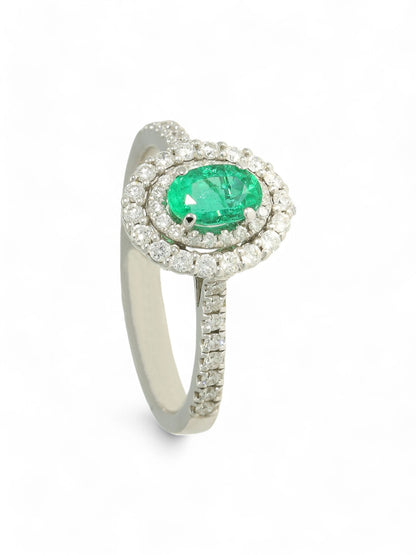 0.45ct Oval Cut Emerald & 0.40ct Round Brilliant Cut Diamond Cluster Ring in 18ct White Gold with Diamond Shoulders