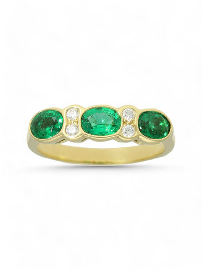 0.93ct Oval Cut Emerald & 0.08ct Round Brilliant Cut Diamond Seven Stone Ring in 18ct Yellow Gold