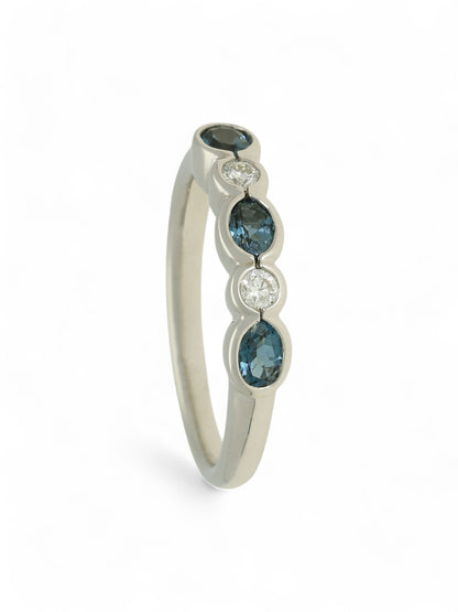 0.55ct Oval Cut Blue Topaz & 0.11ct Round Brilliant Cut Diamond Half Eternity in 9ct White Gold