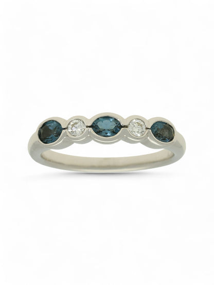 0.55ct Oval Cut Blue Topaz & 0.11ct Round Brilliant Cut Diamond Half Eternity in 9ct White Gold