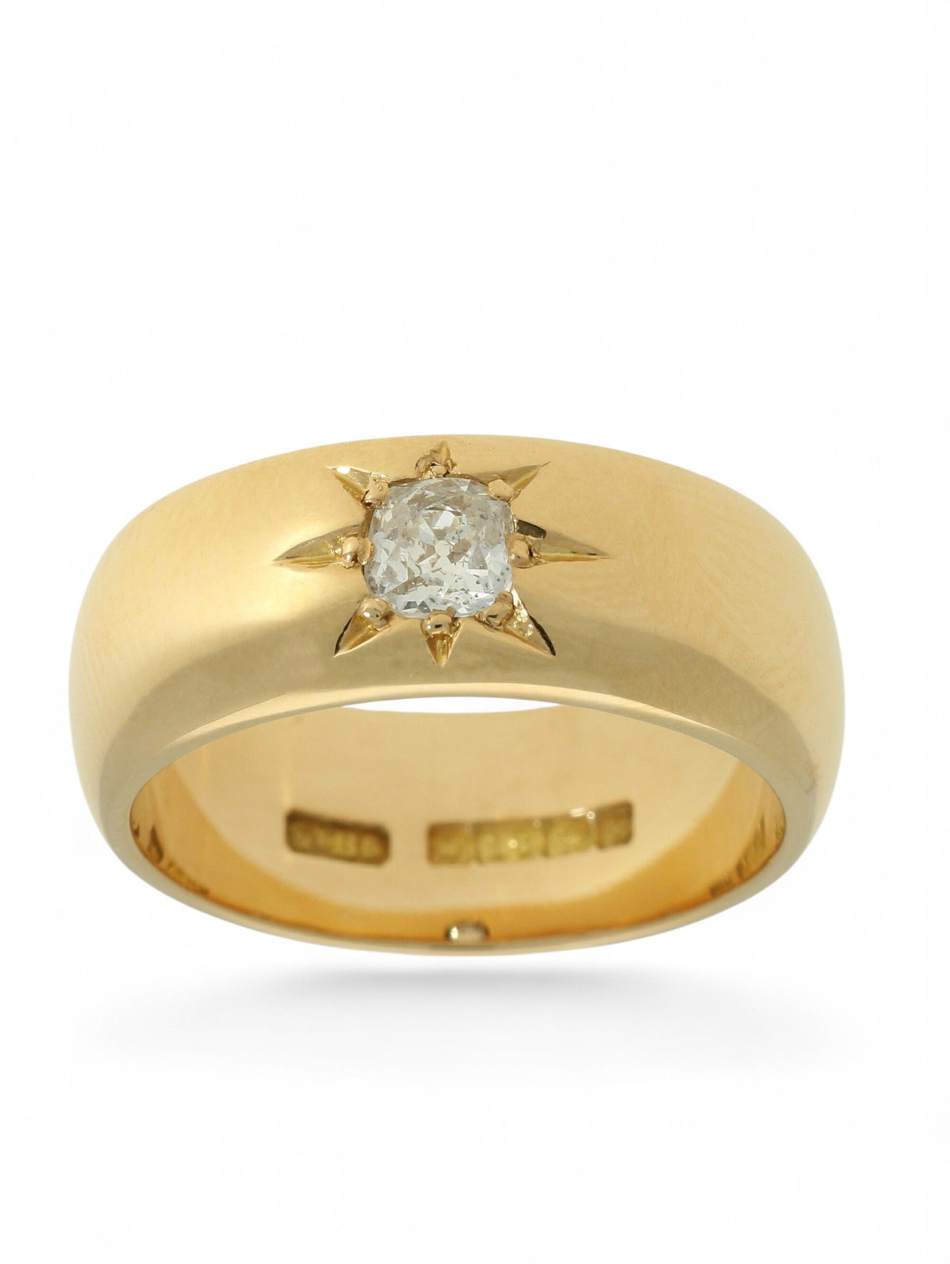18ct yellow gold wide band ring with a single diamond in a star setting on a white background.