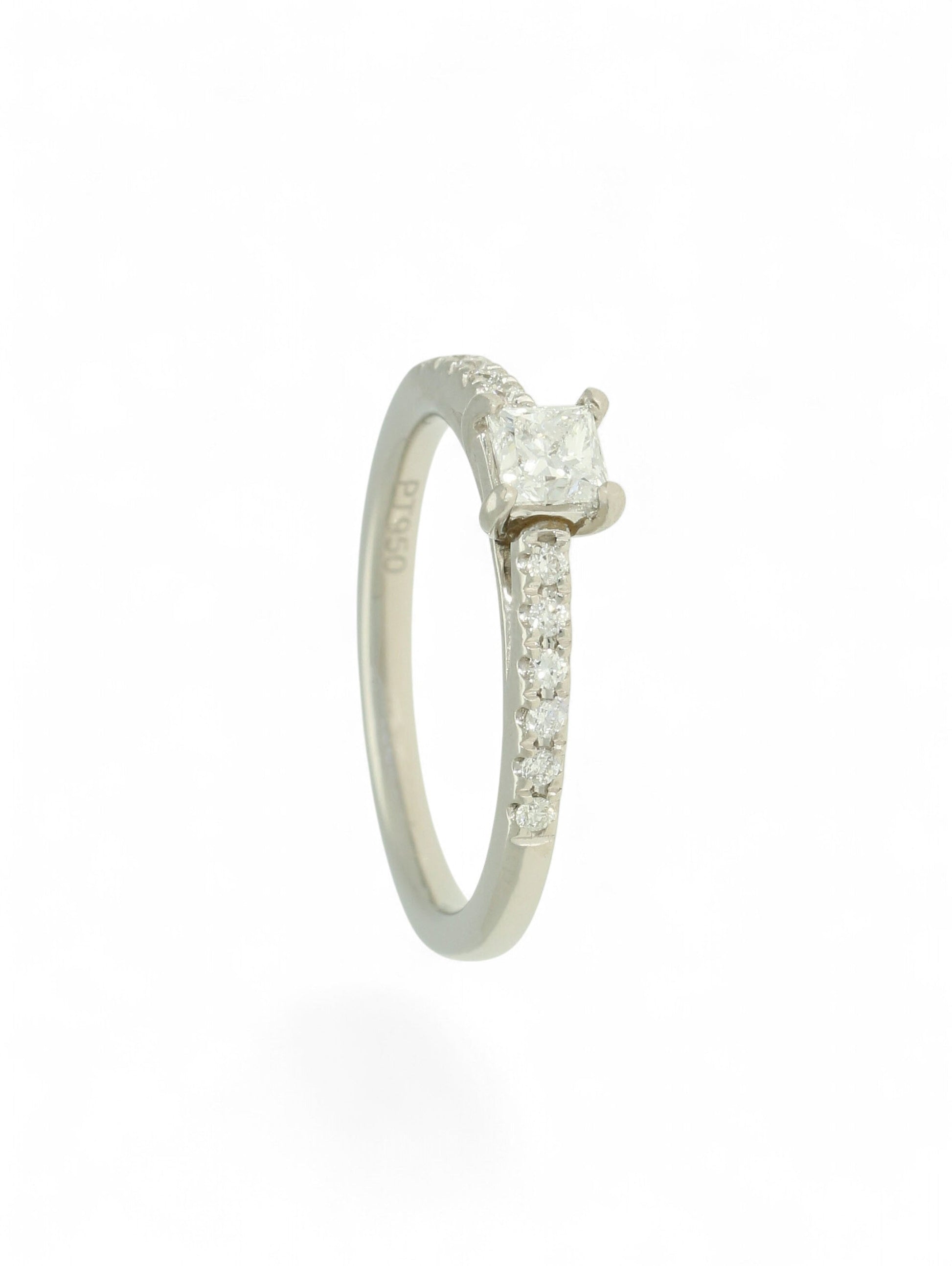 Pre-Owned diamond solitaire ring with a 0.30ct princess cut centre stone in a platinum setting with diamond set shoulders.