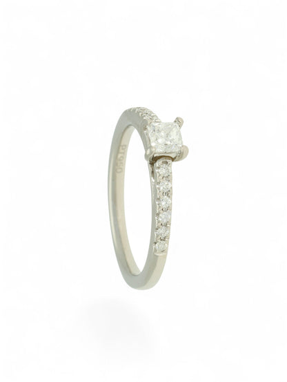 Pre-Owned diamond solitaire ring with a 0.30ct princess cut centre stone in a platinum setting with diamond set shoulders.