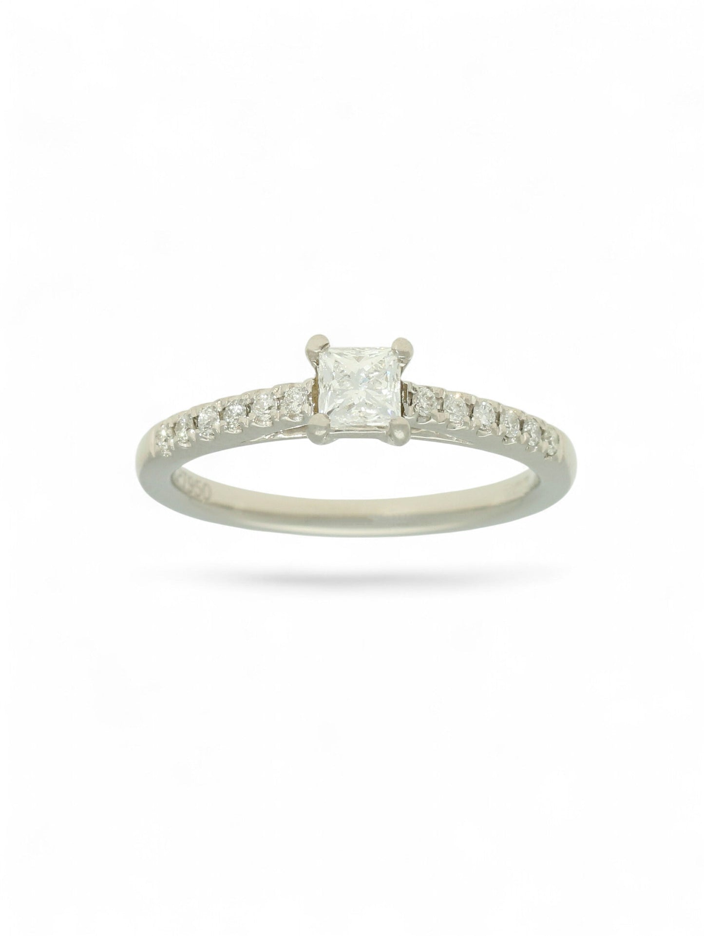 Pre-Owned diamond solitaire ring with a 0.30ct princess cut centre stone in a platinum setting with diamond set shoulders.
