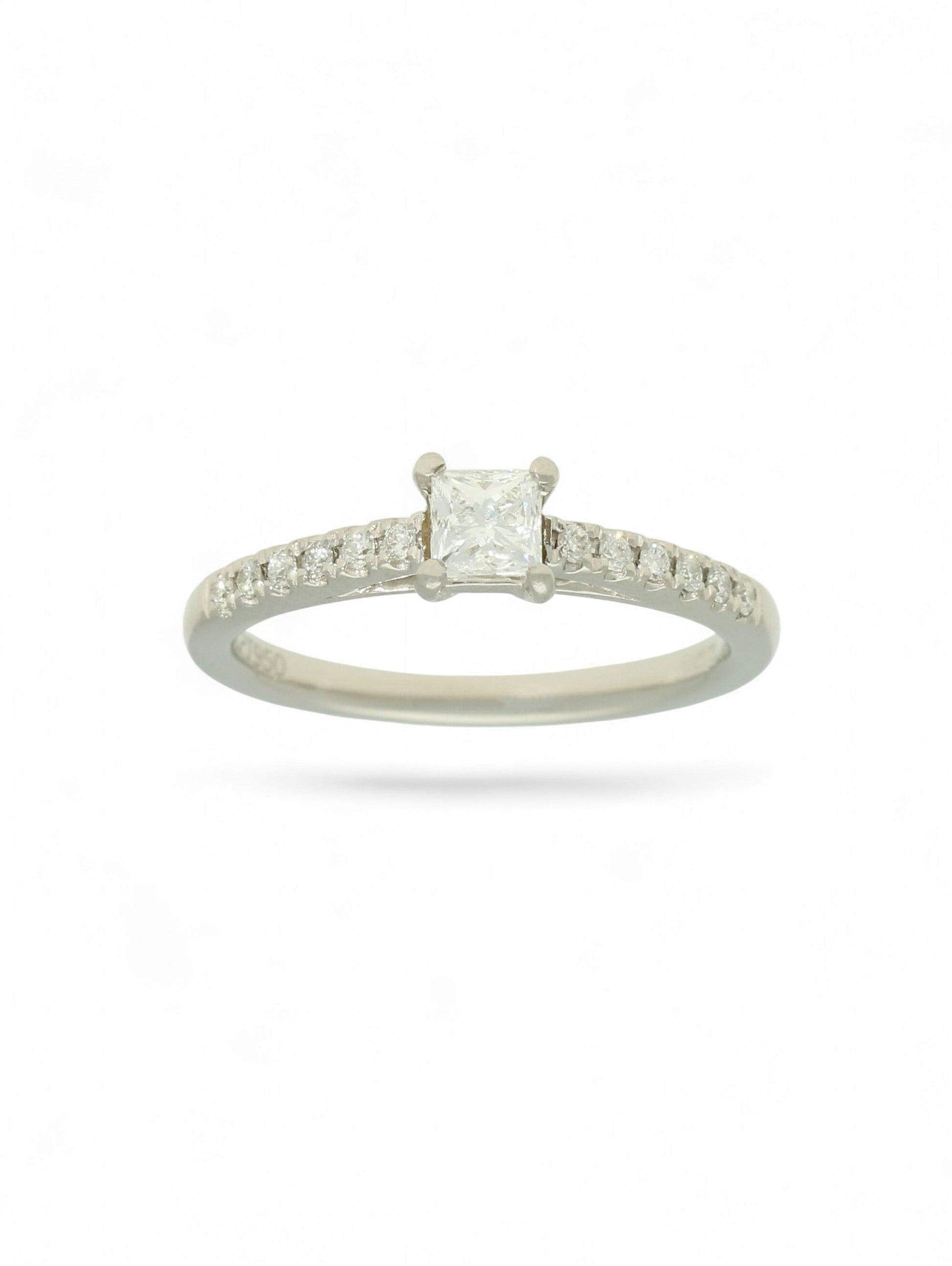 Pre-Owned diamond solitaire ring with a 0.30ct princess cut centre stone in a platinum setting with diamond set shoulders.