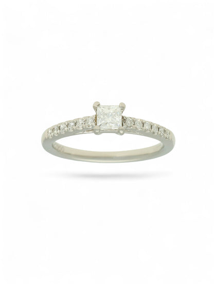Pre-Owned diamond solitaire ring with a 0.30ct princess cut centre stone in a platinum setting with diamond set shoulders.