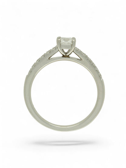 Pre-Owned diamond solitaire ring with a 0.30ct princess cut centre stone in a platinum setting with diamond set shoulders.