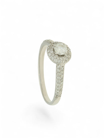 Pre-Owned 9ct white gold diamond halo ring with a 0.25ct centre stone, diamond halo, and diamond set shoulders.
