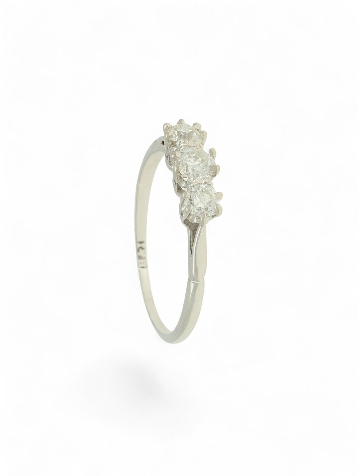 White metal diamond three-stone ring on a white background.