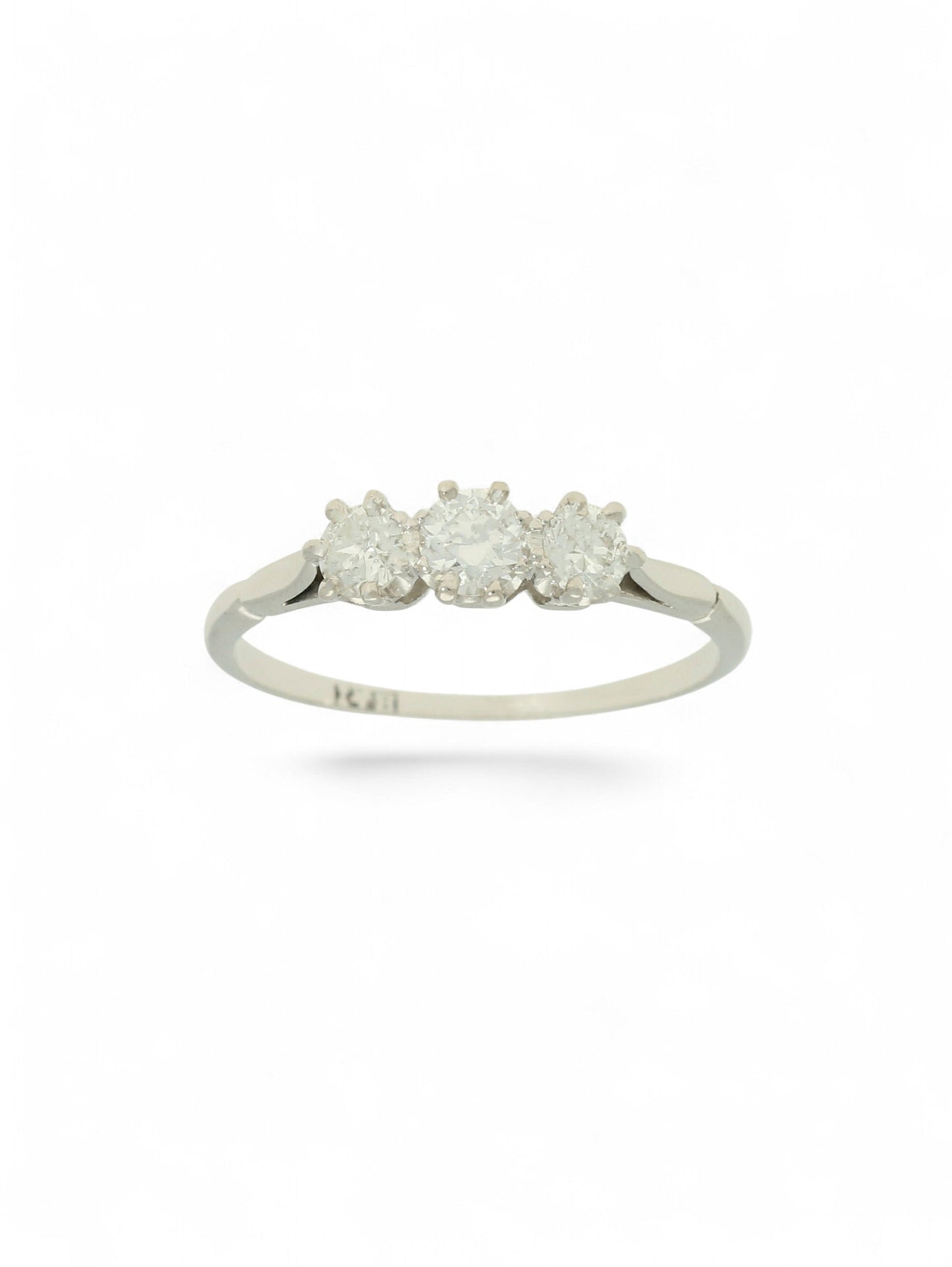 White metal diamond three-stone ring on a white background.