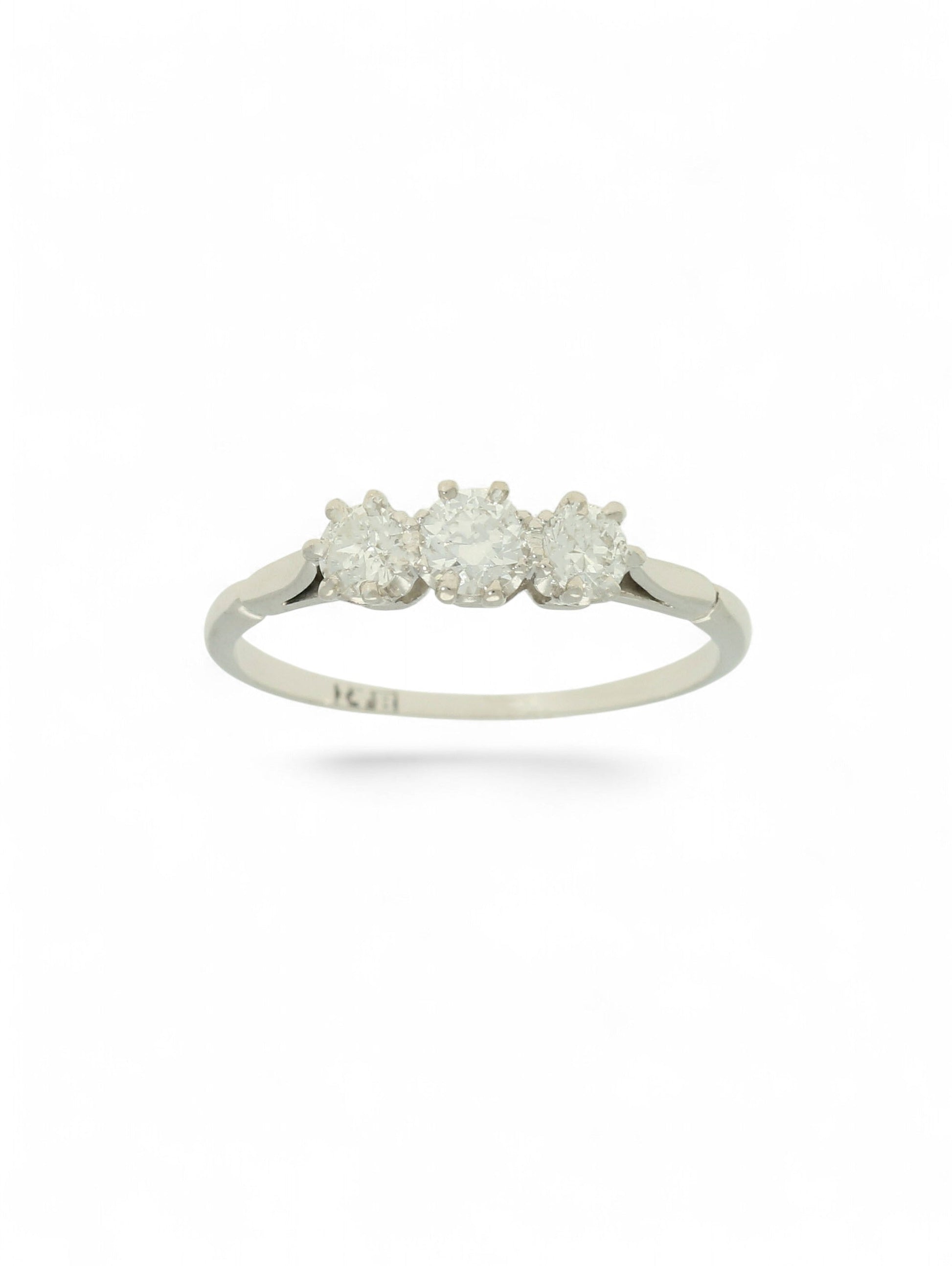 White metal diamond three-stone ring on a white background.