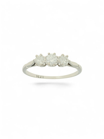 White metal diamond three-stone ring on a white background.