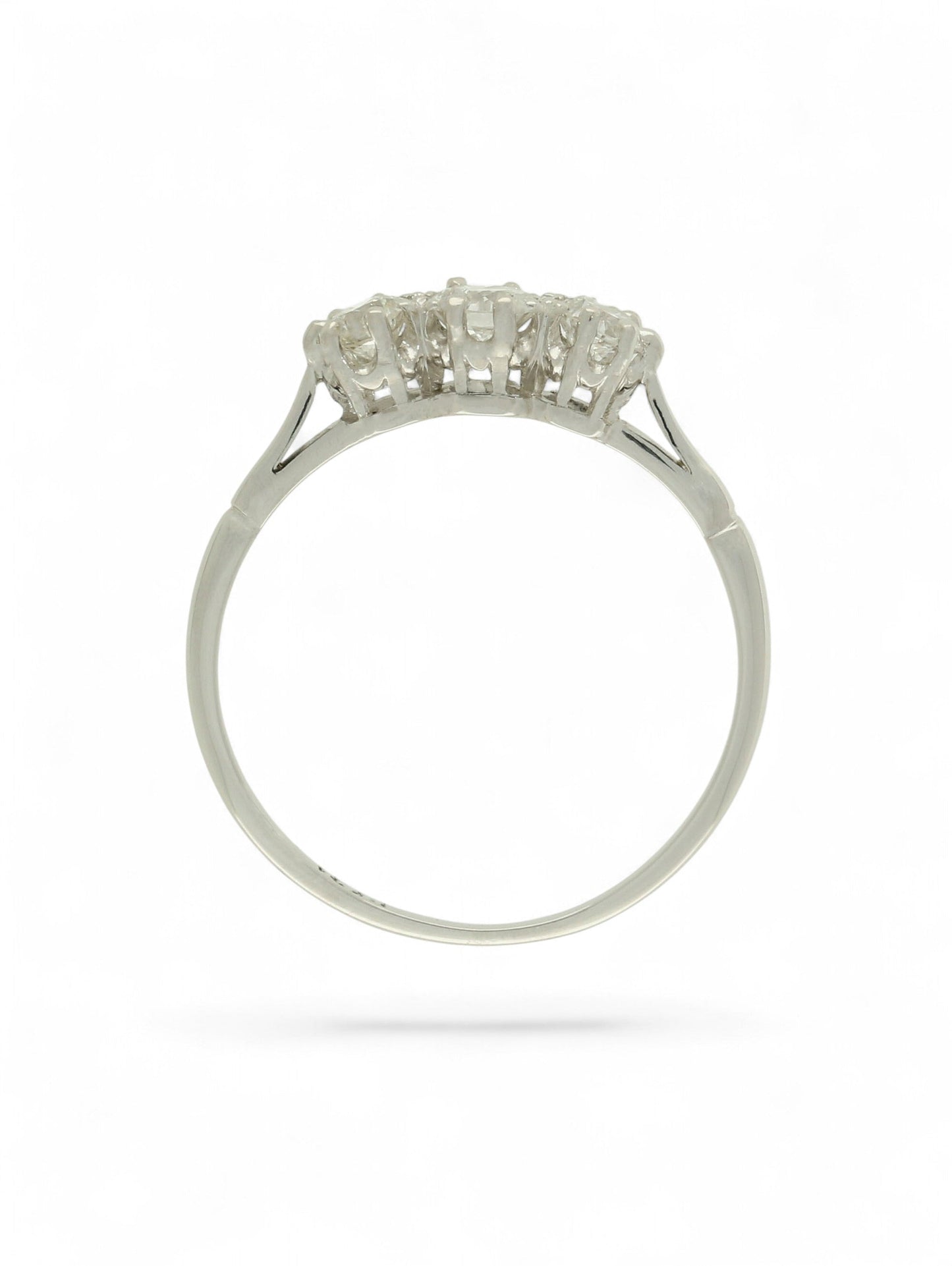 White metal diamond three-stone ring on a white background.