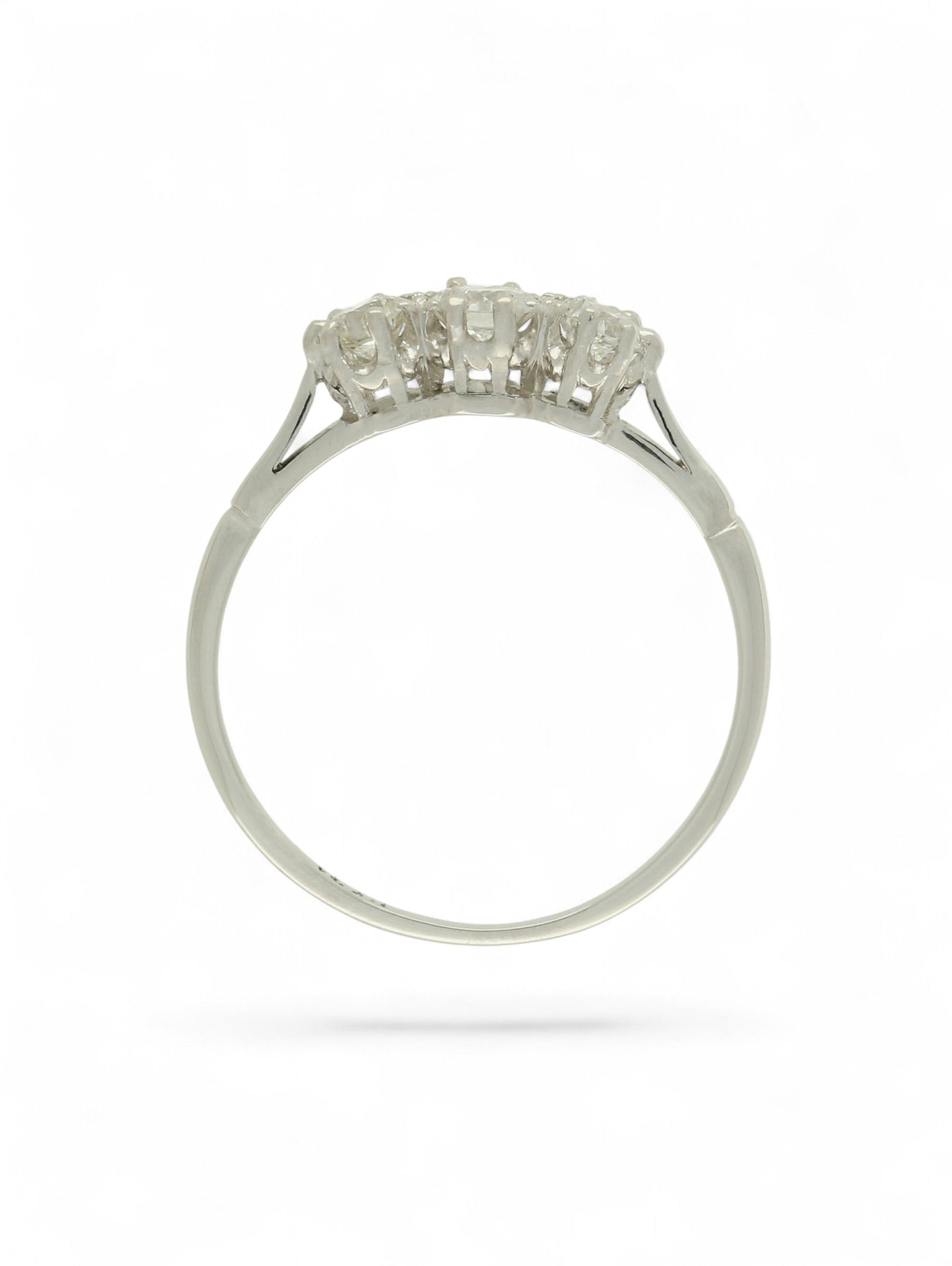 White metal diamond three-stone ring on a white background.
