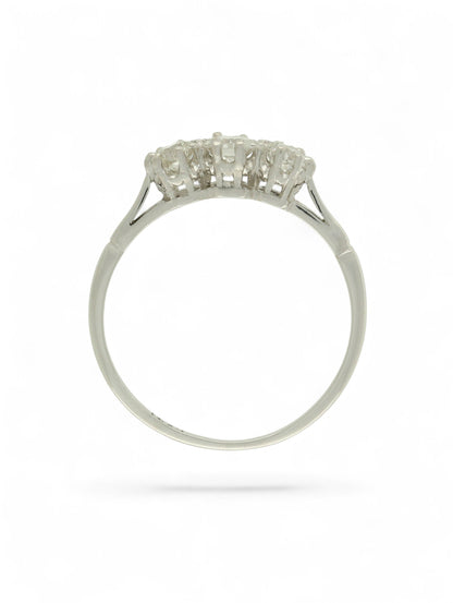 White metal diamond three-stone ring on a white background.