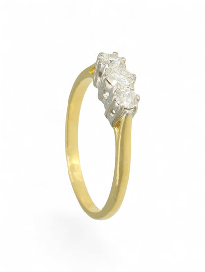18ct yellow and white gold three-stone diamond ring on a white background.