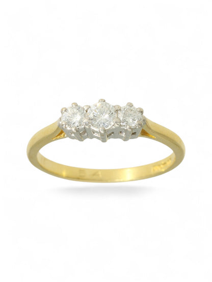 18ct yellow and white gold three-stone diamond ring on a white background.