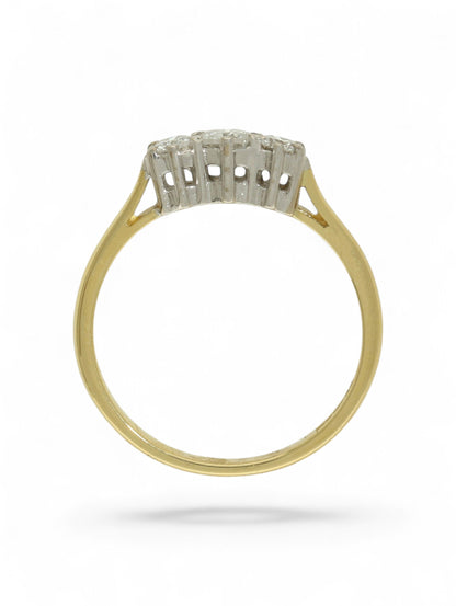 18ct yellow and white gold three-stone diamond ring on a white background.