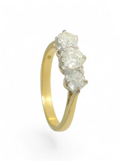 18ct yellow and white gold, diamond three-stone ring on a white background.