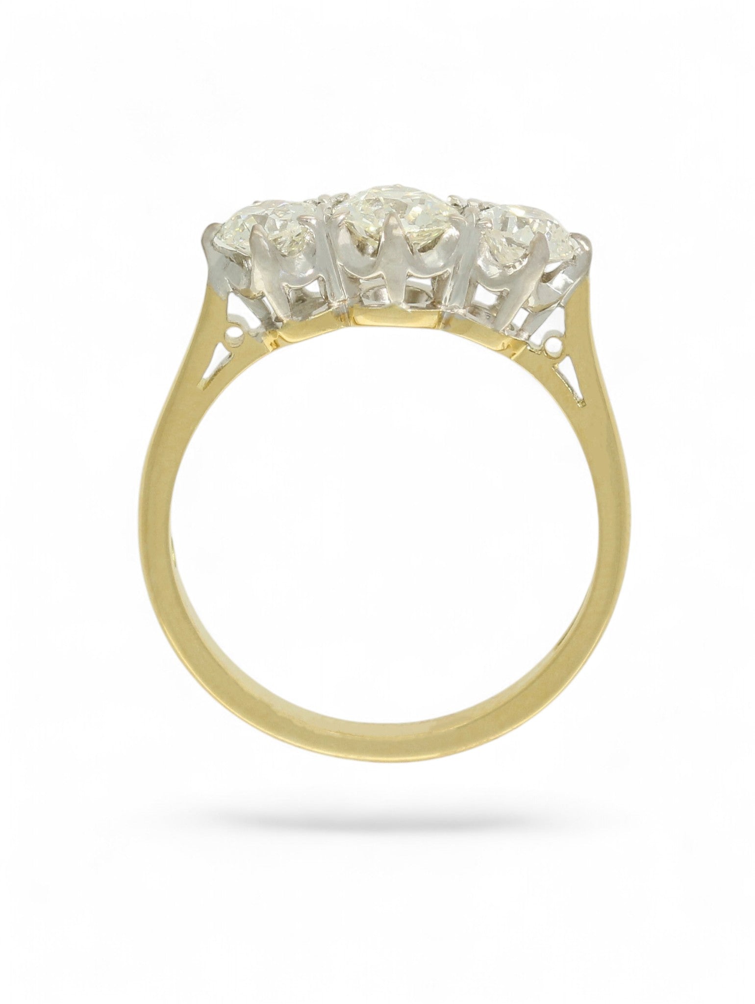 18ct yellow and white gold diamond three-stone ring on a white background.