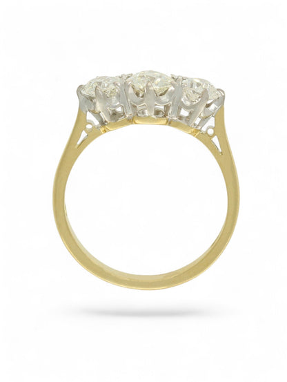 18ct yellow and white gold diamond three-stone ring on a white background.