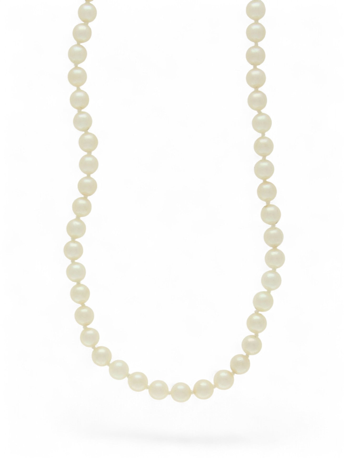 Single-row white pearl necklace on a white background.