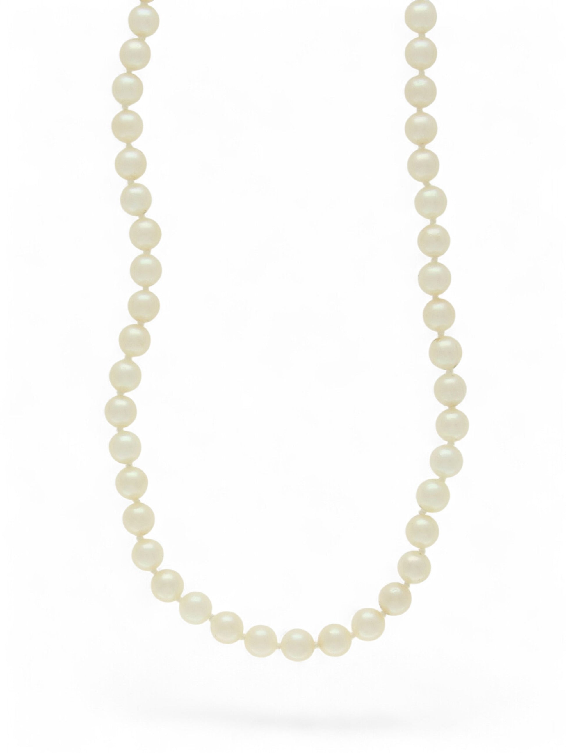 Single-row white pearl necklace on a white background.