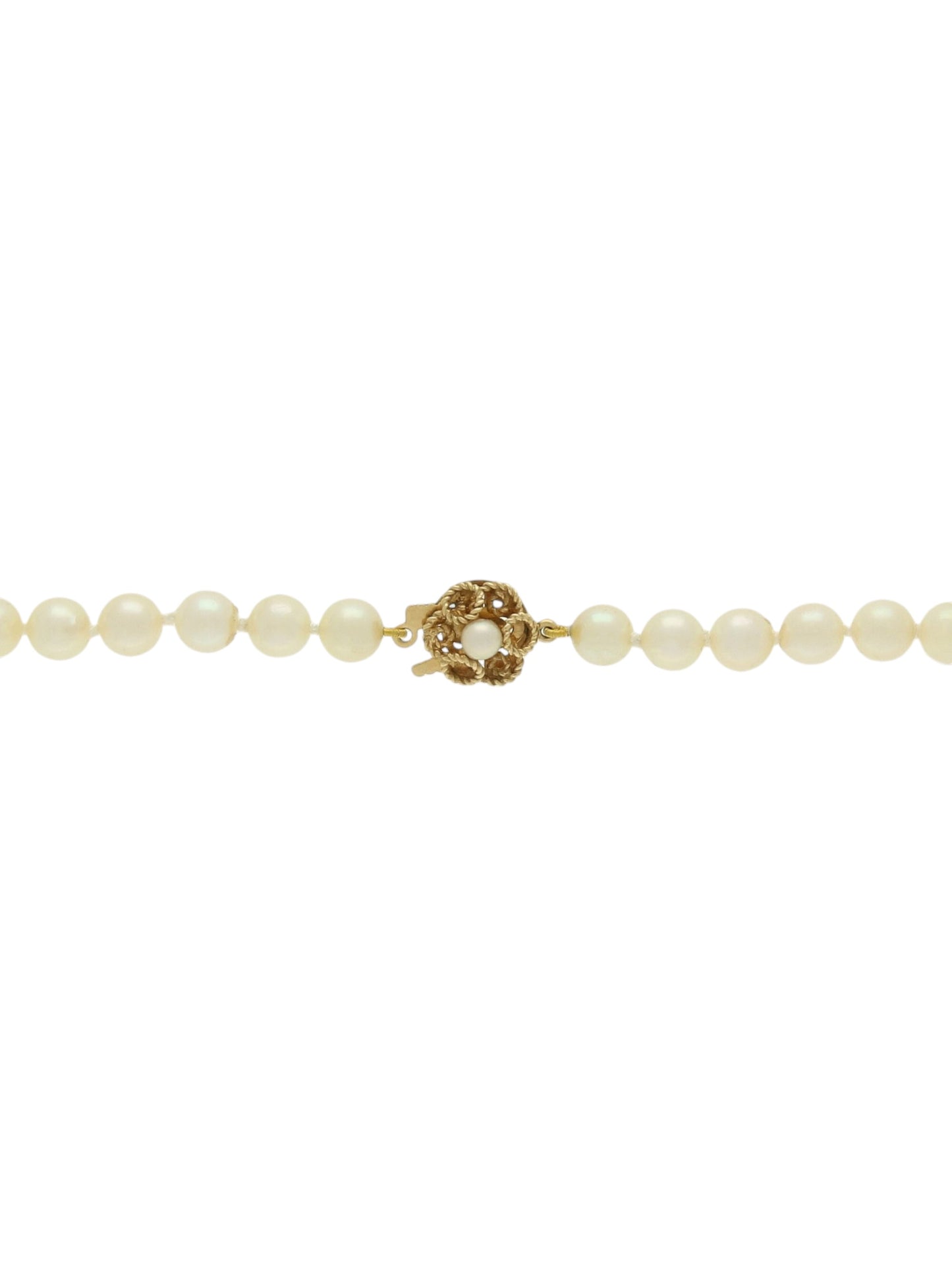 Single strand of white pearls with knot clasp on a white background.