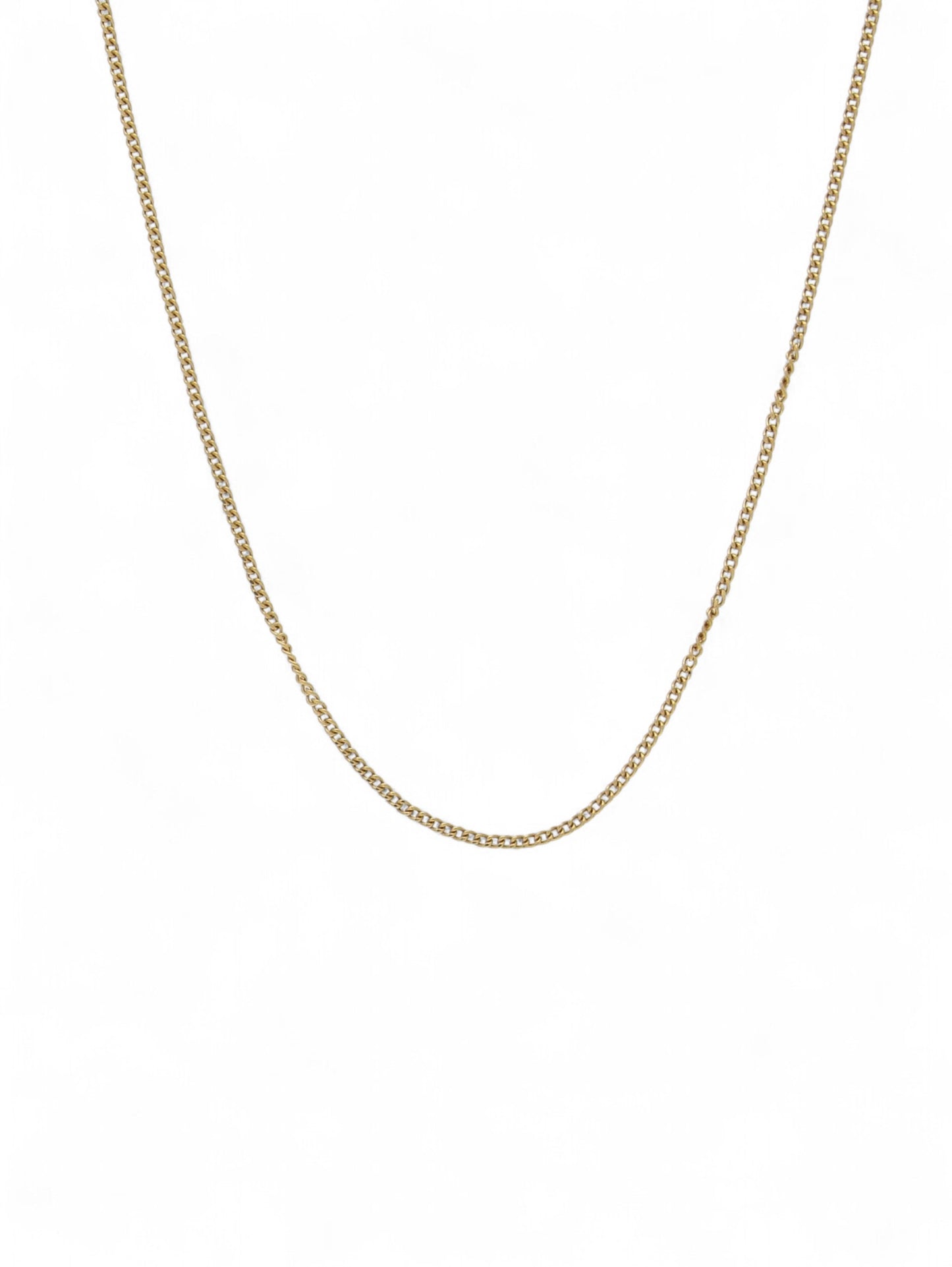 Yellow-gold fine curb chain on a white background.