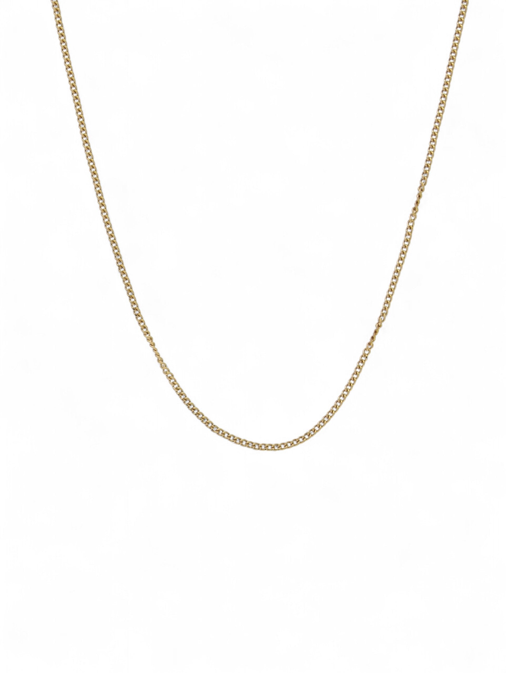 Yellow-gold fine curb chain on a white background.