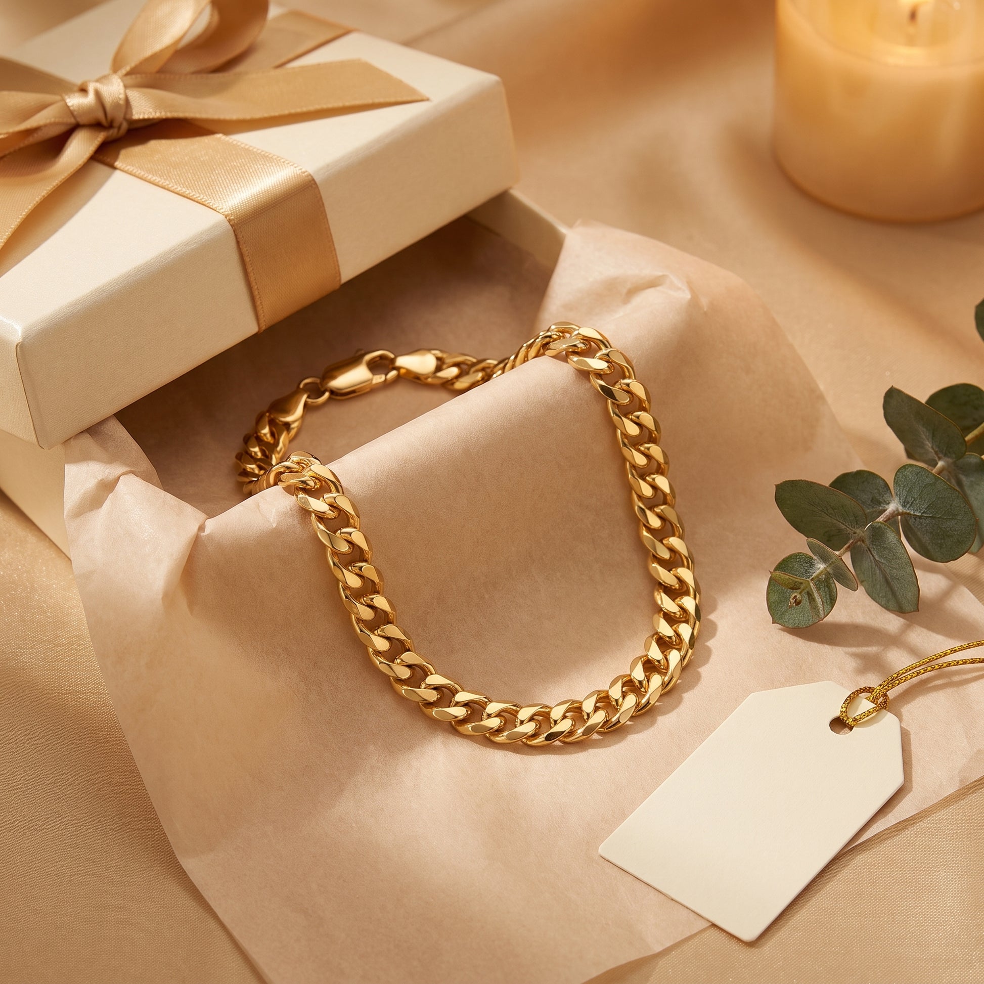 Yellow gold curb link bracelet with trigger clasp in a cream presentation box.