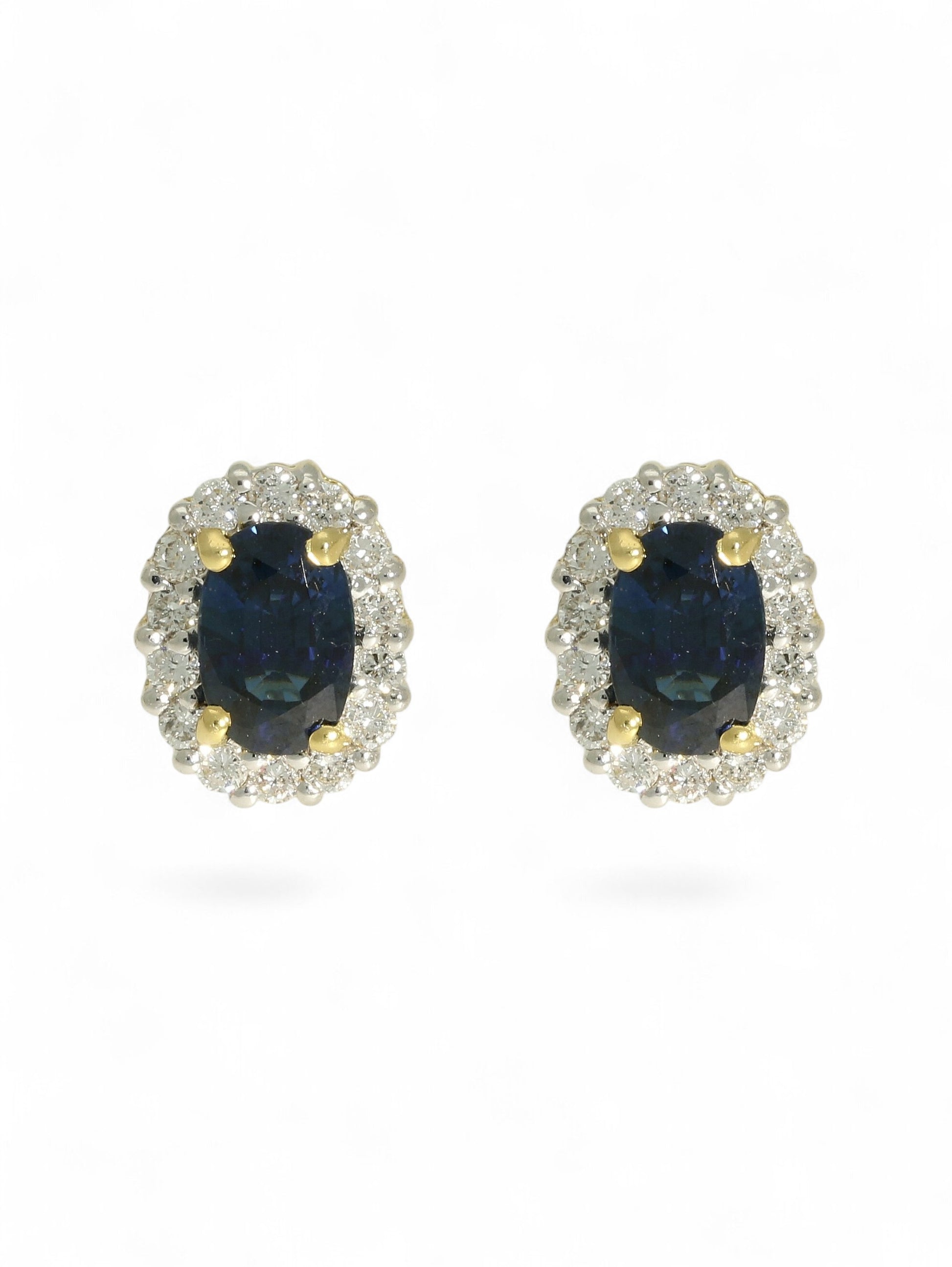 Sapphire & diamond cluster earrings on a white background.