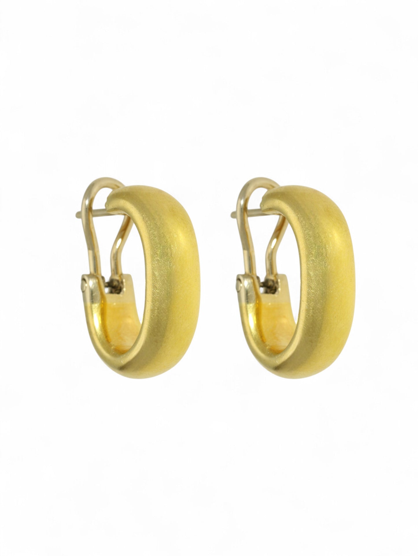 Yellow-gold oval hoop earrings with hinged fitting on a white background.