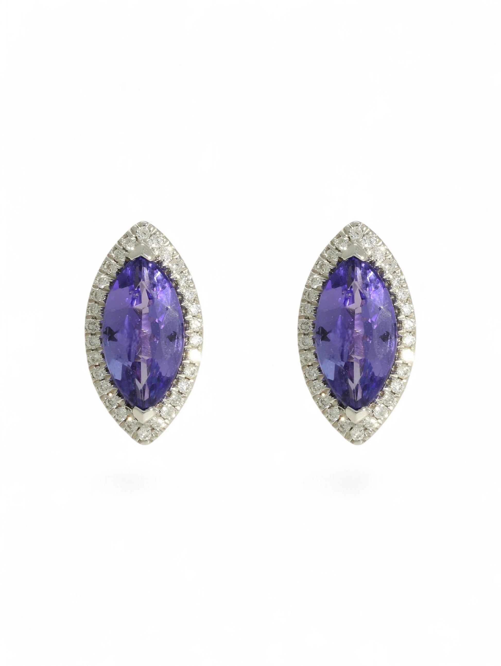 Tanzanite & diamond marquise cluster earrings on a white background.