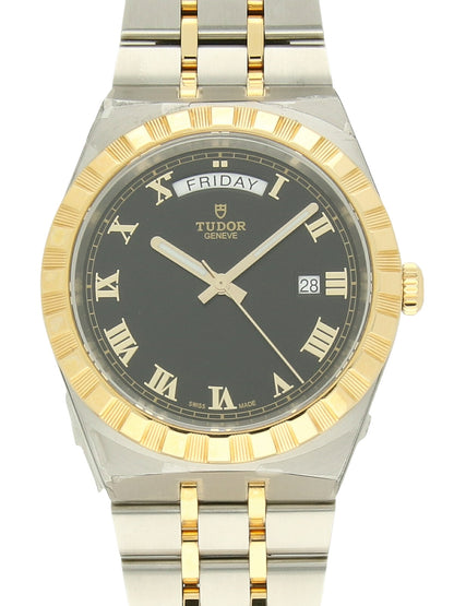 TUDOR Royal watch with steel and yellow-gold bracelet and black dial on a white background.