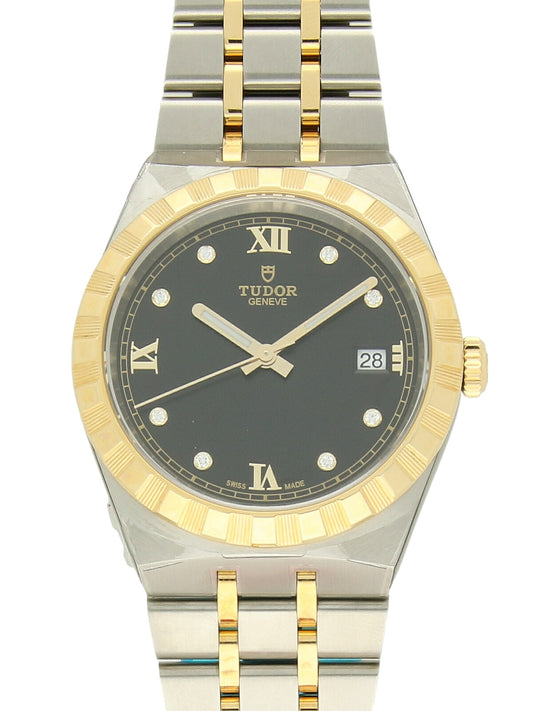 TUDOR Royal watch with steel and yellow-gold bracelet and black dial on a white background.