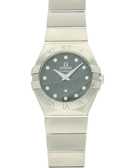 Omega Constellation with steel bracelet and blue  feather, diamond-set dial on a white background.