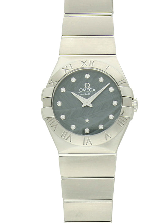 Omega Constellation with steel bracelet and blue  feather, diamond-set dial on a white background.